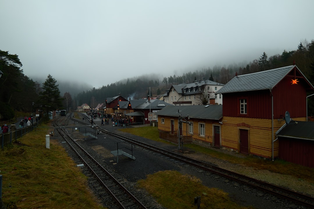 A small village railway station sits quietly beneath fog-covered hills — where local trains still run through one of Central Europes least-visited corners.